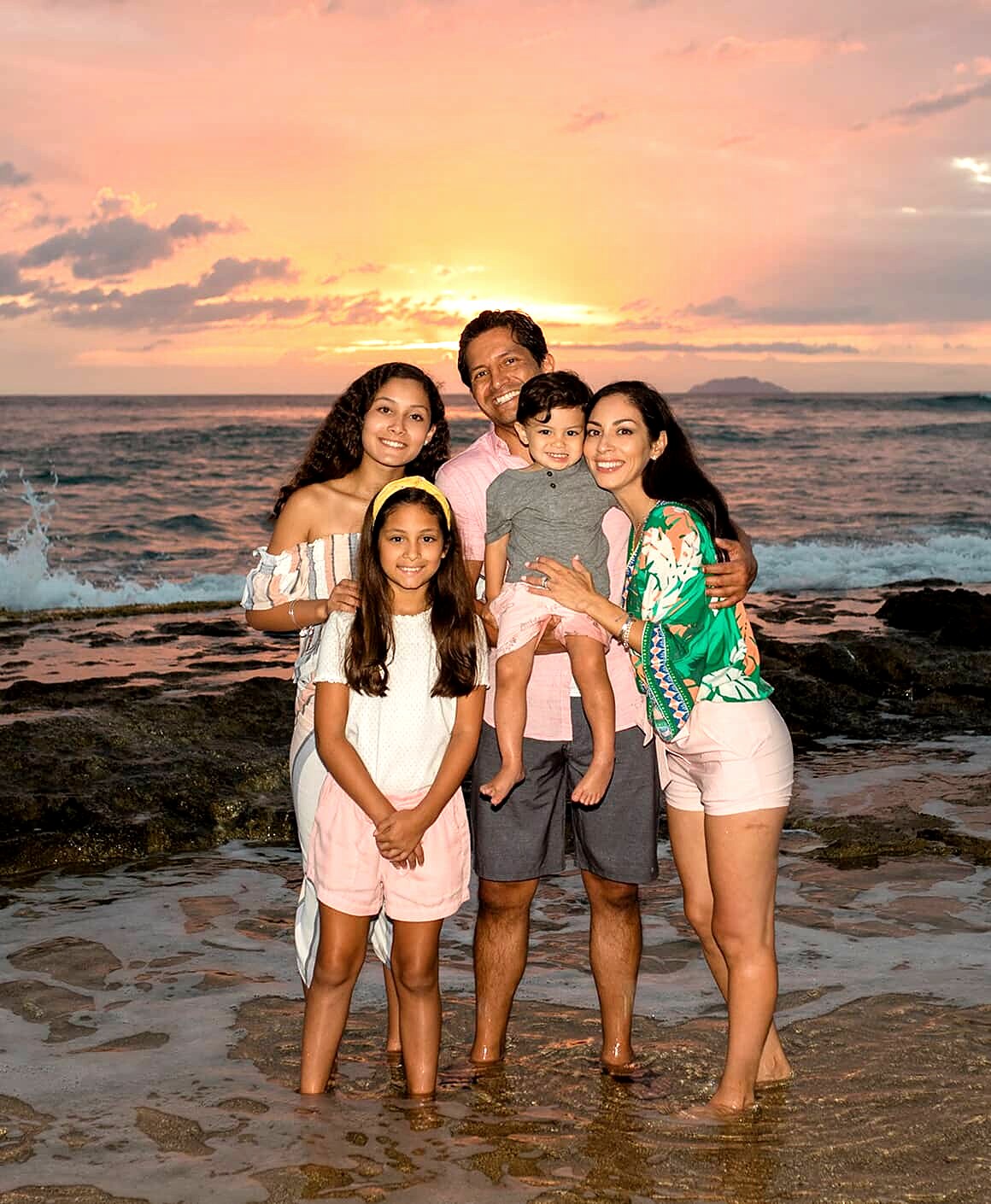 Dr. Ronald Espinoza with his family by the ocean